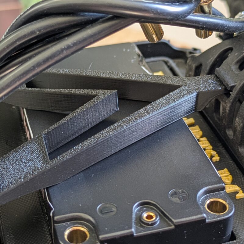 Close-up of 3D printed battery strap installed on Team Associated B5M buggy
